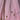Three elegant necklaces displayed on a stand against a soft pink background.