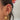 Gold celestial ear stack featuring sun, star and crystal huggie hoops, layered with dainty cuffs and chains