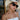 Chic summer outfit featuring white floral enamel jewellery, layered gold necklaces, and matching clover stud earrings styled with a wide sun hat and black sunglasses