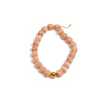 Necklace with pink beads and a gold accent on a white background
