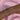 A close-up of a woman's forearm adorned with ten delicate silver bracelets, displayed against a soft pink satin background. The bracelets feature a variety of designs including pearls, crosses, starbursts, heart-shaped crystals, floral motifs, and rows of small sparkling stones. Each bracelet has a feminine and elegant aesthetic, with some using rose gold-toned chains.