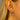 Close-up of a woman's ear wearing a sparkly silver hoop earring with a red heart-shaped charm surrounded by small clear stones – elegant and romantic design.