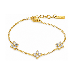A gold chain bracelet with three flower motifs set with clear stones, shown on a plain white background. A small tag near the clasp reads S.