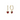 gold earrings with a red crystal in the middle placed on a white background