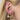 Triple gold hoop earring stack with crystal heart and key charms and a larger celestial hoop adorned with navy blue stars, worn on a blonde-haired model.