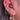 Close-up of an ear with multiple gold and diamond earrings.