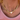 Gold chain necklace with a heart-shaped pendant worn by a person in a pink top.