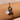 Bracelet with a flower charm and heart-shaped charm on a wrist against a light background