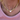 Gold chain necklace with a heart-shaped pendant worn by a person in a pink top.