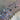 Stacked silver bangles featuring hearts, floral charms, Roman numerals and crystal accents, styled as a trending arm candy bracelet set for a luxury look.