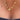 Gold star-shaped necklace on a person wearing a dark top.
