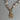 Necklace with spiral pendant and shell beads on a gray background