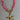 Necklace with pink beads and a gold starfish pendant on a gray background