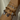 Close-up of a wrist wearing multiple bracelets with various charms on a neutral background.