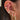 Close-up of an ear with multiple gold and diamond earrings.