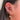 Close-up of an ear with multiple gold and diamond earrings.