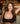 Woman in a black top posing in a bar setting