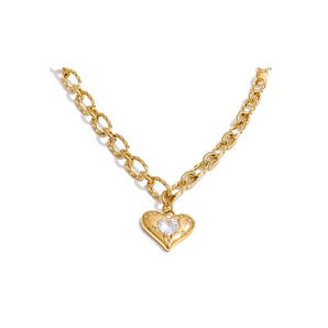 Gold chain necklace with a heart-shaped pendant on a white background
