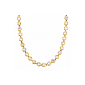 Gold necklace with clear gemstones on a white background