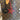 Louis Vuitton handbag with star-shaped name tags labeled 'belle' and 'binky'. Bag charms