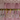 Sparkling crystal hoop earrings in gold and silver with heart and moon star charms, displayed on a jewellery stand against a soft pink backdrop