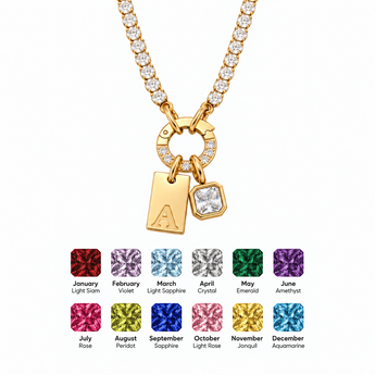 A gold-toned initial necklace with a charm displaying the letter 'A', shown on a white background with twelve color options for the initial charm at the bottom.