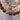 Two beaded necklaces with multicolored beads on a light background
