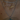 A close-up of layered necklaces on a woman's neck, featuring a silver tennis choker, a gold nameplate necklace that says “Natalia” with pearl accents, and a silver rope chain with a detailed silver flower pendant.