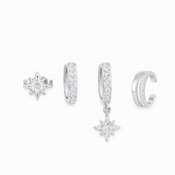 4 different silver earrings with diamonds placed on a white backgrounds 