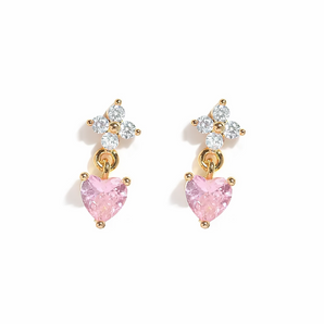 Pair of earrings with pink heart-shaped stones on a white background