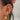 Gold celestial ear stack featuring sun, star and crystal huggie hoops, layered with dainty cuffs and chains