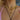 Close-up of a woman wearing layered gold necklaces, including a twisted choker, a heart link chain, a lock pendant, and a bold circular pendant on a black cord. She pairs the look with chunky gold hoop earrings and a light pink patterned top with thin straps.