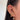 Close-up of an ear adorned with multiple gold earrings. Designs include stars, crescents, bows, and a heart-shaped gem, conveying a trendy, fashionable style.