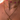 Layered gold necklaces on a woman's neck, featuring a floral choker with pink beads, a dainty “Binky” and “Belle” nameplate chain with a pavé heart in the centre, and a rope chain with a bold flower-shaped pendant.