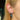 Stacked silver and blue huggie hoop earrings with star and teardrop charms on blonde model ear