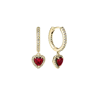 gold earrings with a red crystal in the middle placed on a white background