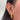 Close-up of an ear adorned with multiple gold and diamond piercings, including hoops, studs, and a large hoop earring. The tone is stylish and elegant.