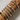 Stacked silver bangles and charm bracelets with crystal and enamel details, worn on wrist against a white background, showcasing elegant arm candy styling.