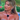 Woman with long blonde hair styled in a half-up look, wearing teardrop crystal earrings and a gold Dior choker necklace, dressed in a bright blue bandeau top on Love Island.