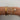 A stack of five delicate bracelets worn on a person's wrist, featuring gold and silver-tone metals with clear stones and floral details, set against a plain light gray background.