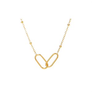 Gold necklace with a unique heart-shaped pendant on a white background