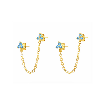 Gold chain stud earrings with blue crystals embellished placed on a white background