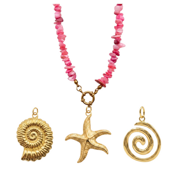 Necklace with pink beads and gold sea-themed pendants on a white background