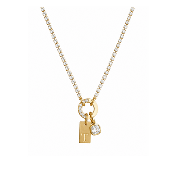A gold necklace with a box chain, featuring a circular ring adorned with small clear stones, a small rectangular gold tag pendant engraved with the letter 'T', and a small oval clear stone charm.