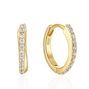 Gold hoop earrings with embedded diamonds on a white background