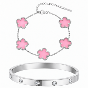 A jewelry set featuring a silver-toned bangle bracelet with clear rhinestones and a matching delicate chain bracelet with five pink flower charms outlined in silver-toned metal, shown on a plain white background.