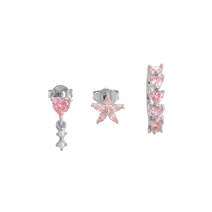 Set of pink and silver earrings on a white background