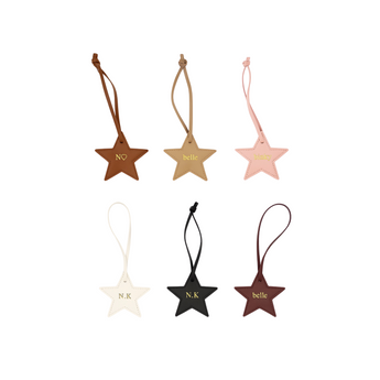 Set of star-shaped keychains in various colors with names engraved on them. Bag charm