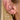 Gold 9mm and 15mm hoop earrings stacked on blonde model ear with size labels